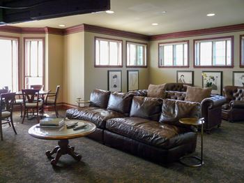 Clubhouse lounge with leather seating and portraits